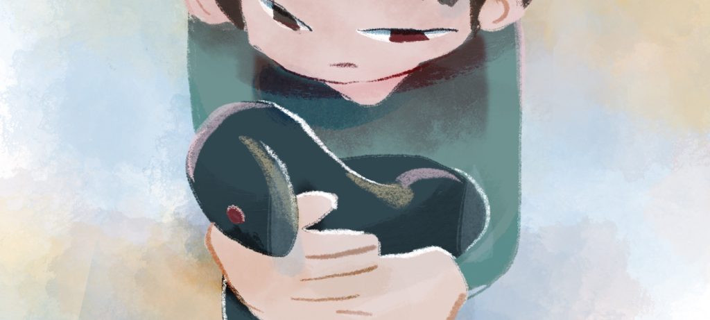 大きな手に抱えられている緑色のへび